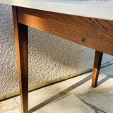 Vintage oak farmhouse table with a white top.