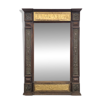 Renaissance-style mirror in wood and copper with a craftsmanship theme.