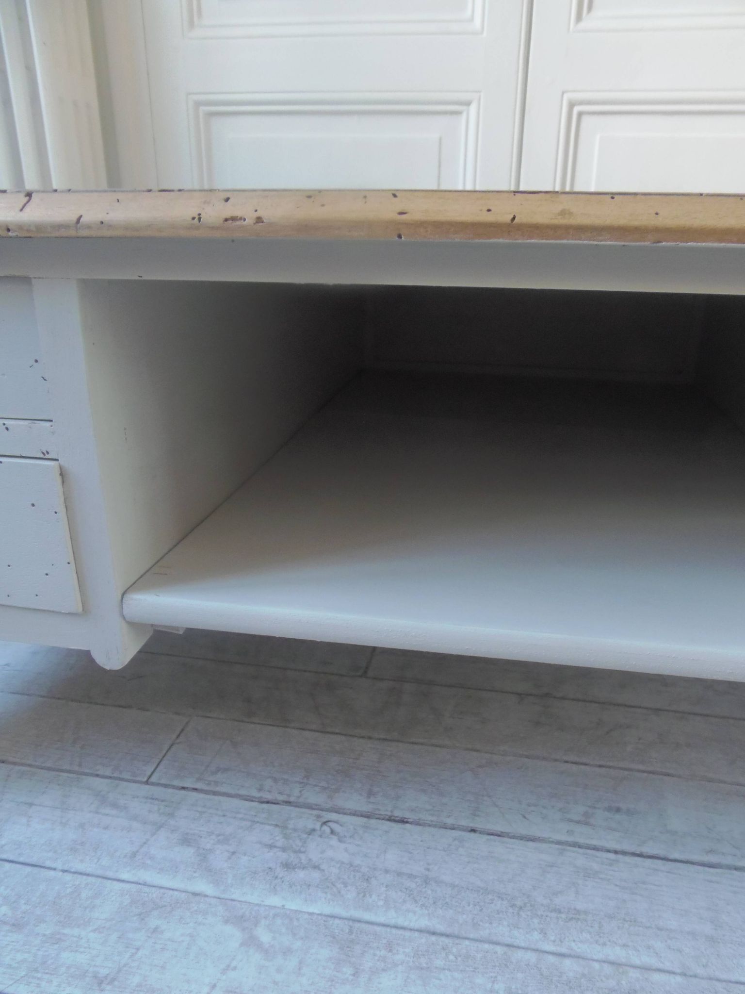 Coffee table on casters, made from an old desk, pearl gray base and belt.