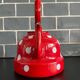 Red enameled sheet metal kettle with white polka dots