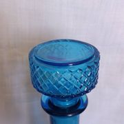 Turquoise glass carafe bottle with a stopper.