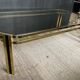 Table basse vintage années 70 en métal doré et verre fumé