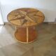 Round coffee table in bamboo, rattan, and wood with an 80s star pattern.