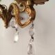 Rococo-style wall lamp in gilded bronze and crystal stamps