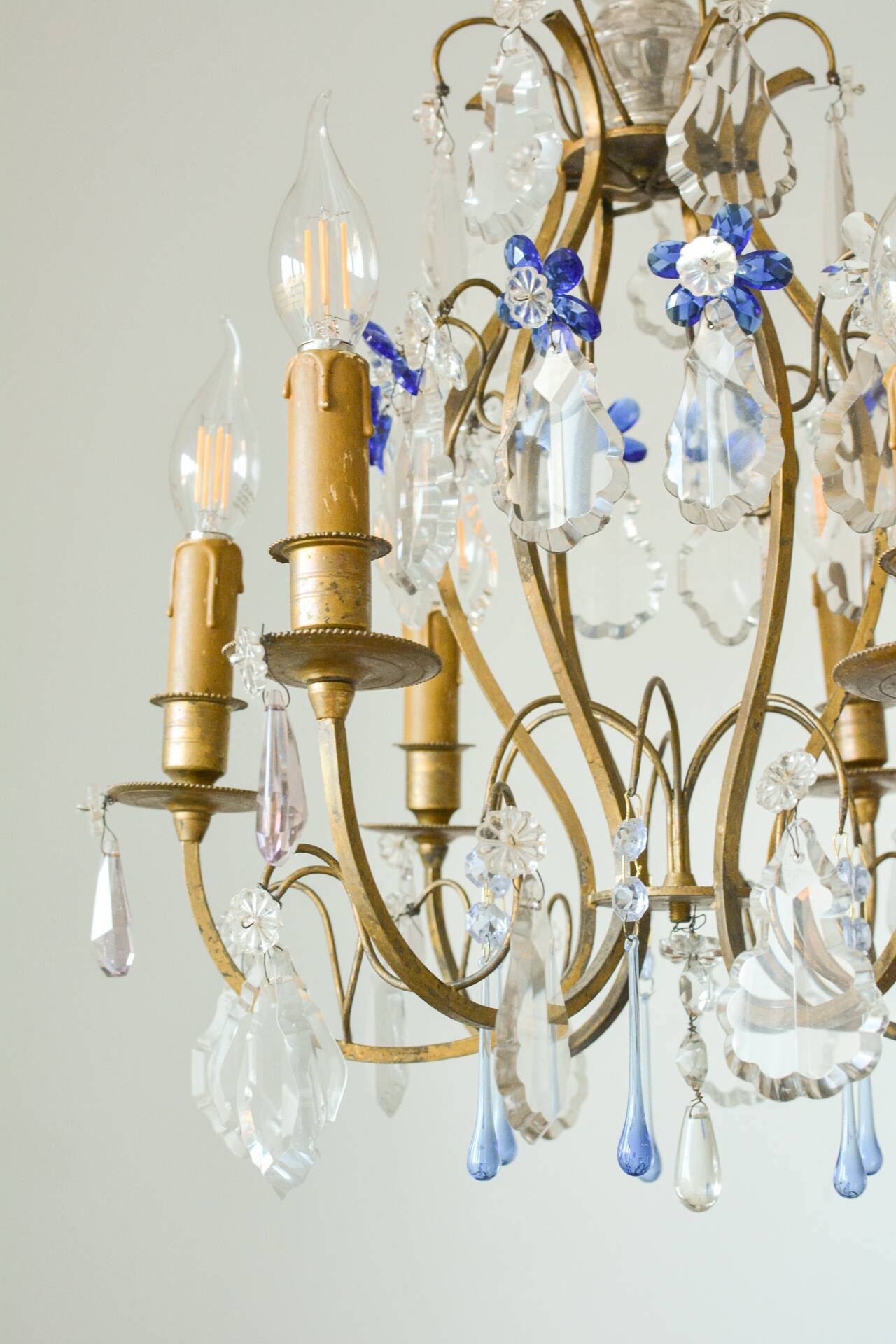 Antique French chandelier cage in gilded bronze and crystal, with blue pendants.