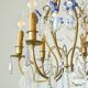 Antique French chandelier cage in gilded bronze and crystal, with blue pendants.