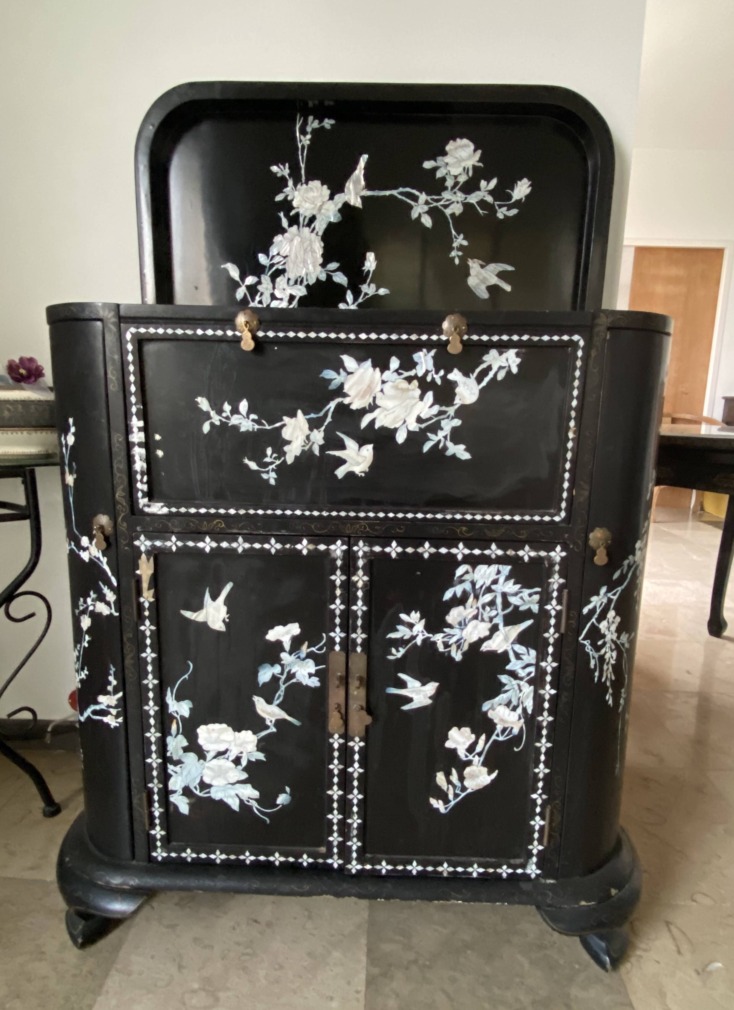 Black lacquered artisanal bar with mother-of-pearl inlays.