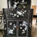 Black lacquered artisanal bar with mother-of-pearl inlays.