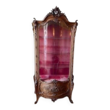 Large wooden display cabinet in Louis XV/rococo style with a strongly curved front.