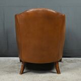 Solange club armchair in sheepskin leather.