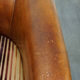 Set of 2 cognac-colored sheepskin club chairs with colorful fabric cushions