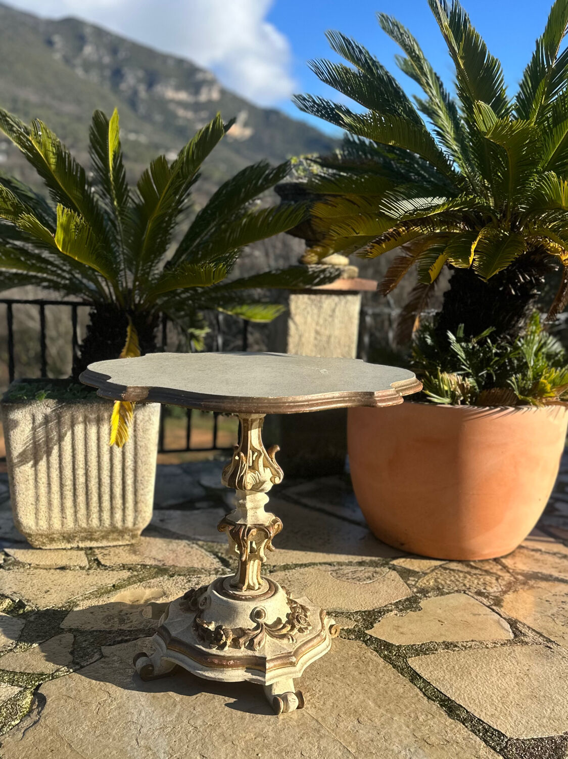 Carved and lacquered wooden side table.