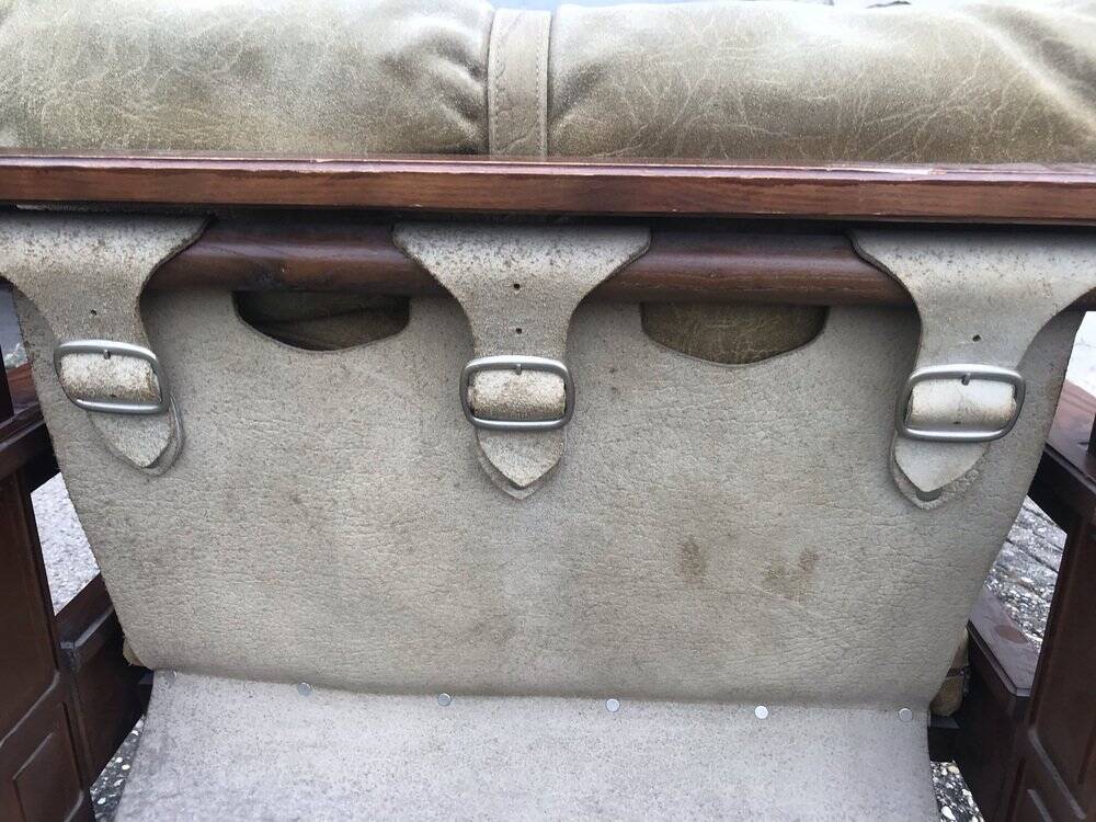 Set of 4 brown leather and wood armchairs with footstools, vintage 1960s style.