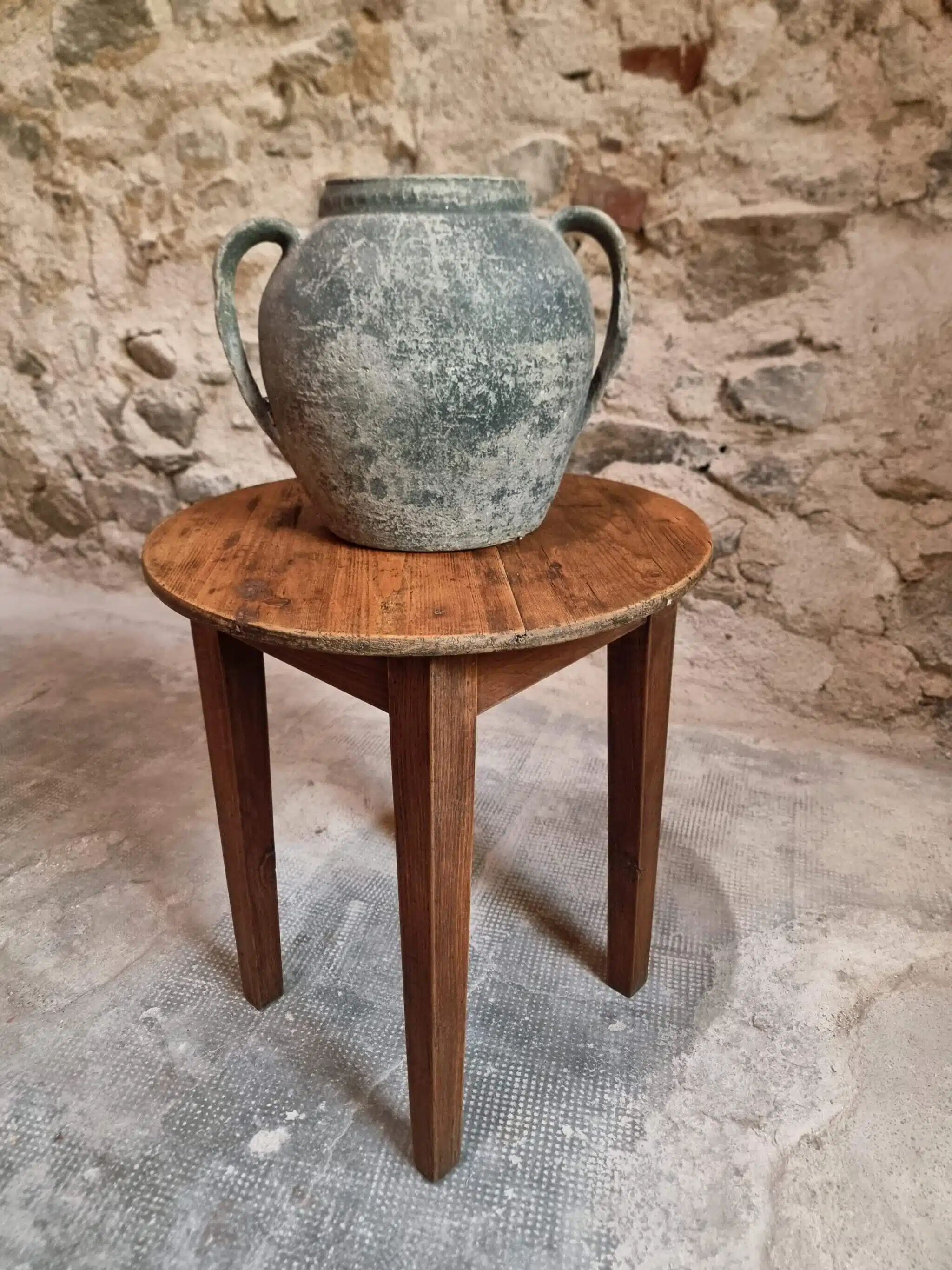 Antique round side table with oak legs and a pine top, circa 1900.