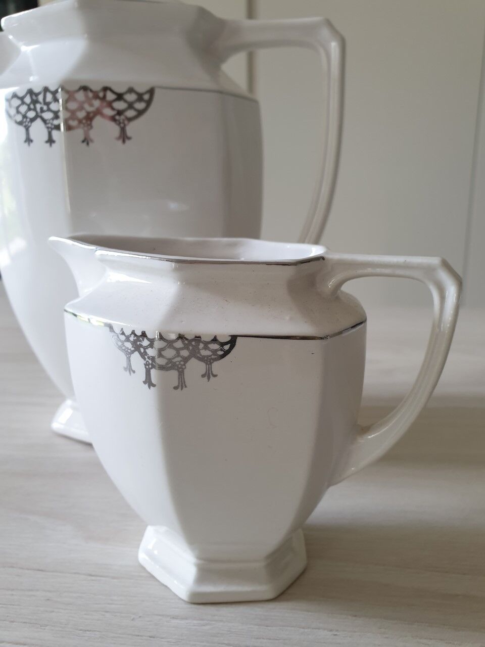 Old coffee maker and its milk pot