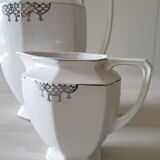 Old coffee maker and its milk pot