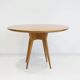 Round dining table in Wood Wood with brass details.