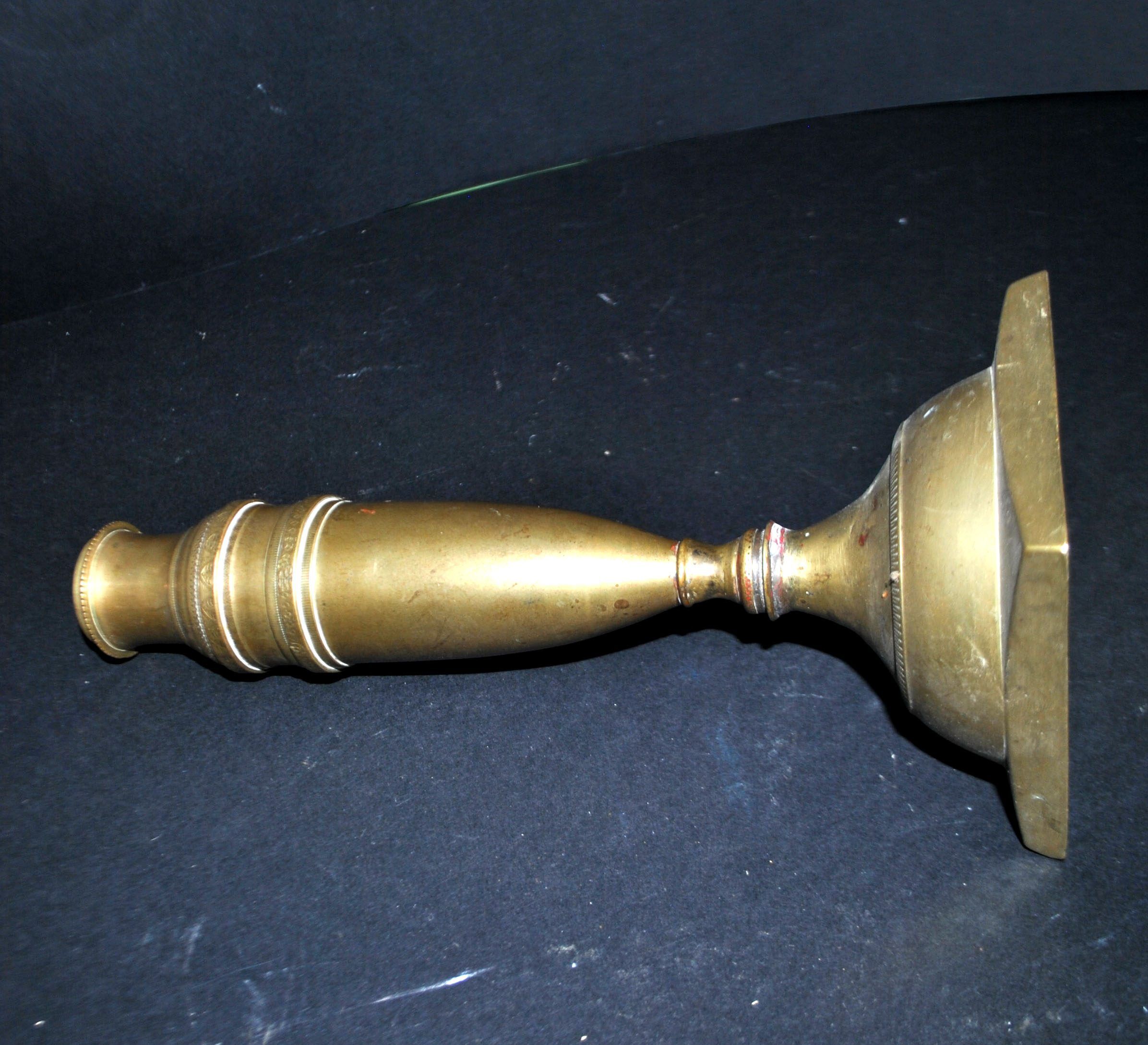 Antique baluster candlestick in bronze with hand-chiseled design.