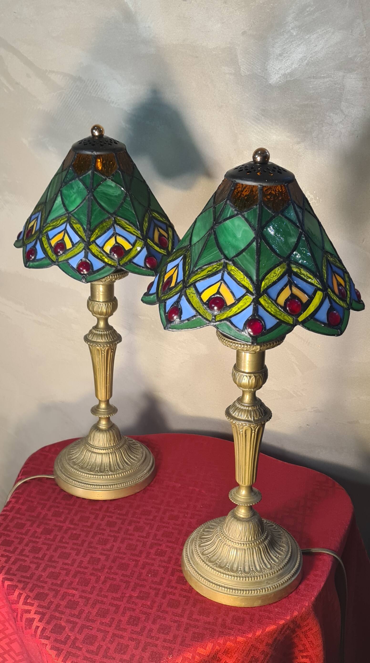 Pair of art nouveau bronze lamps, Tiffany-style glass lampshades