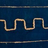 Cushion has Greek metis tie and dye pattern