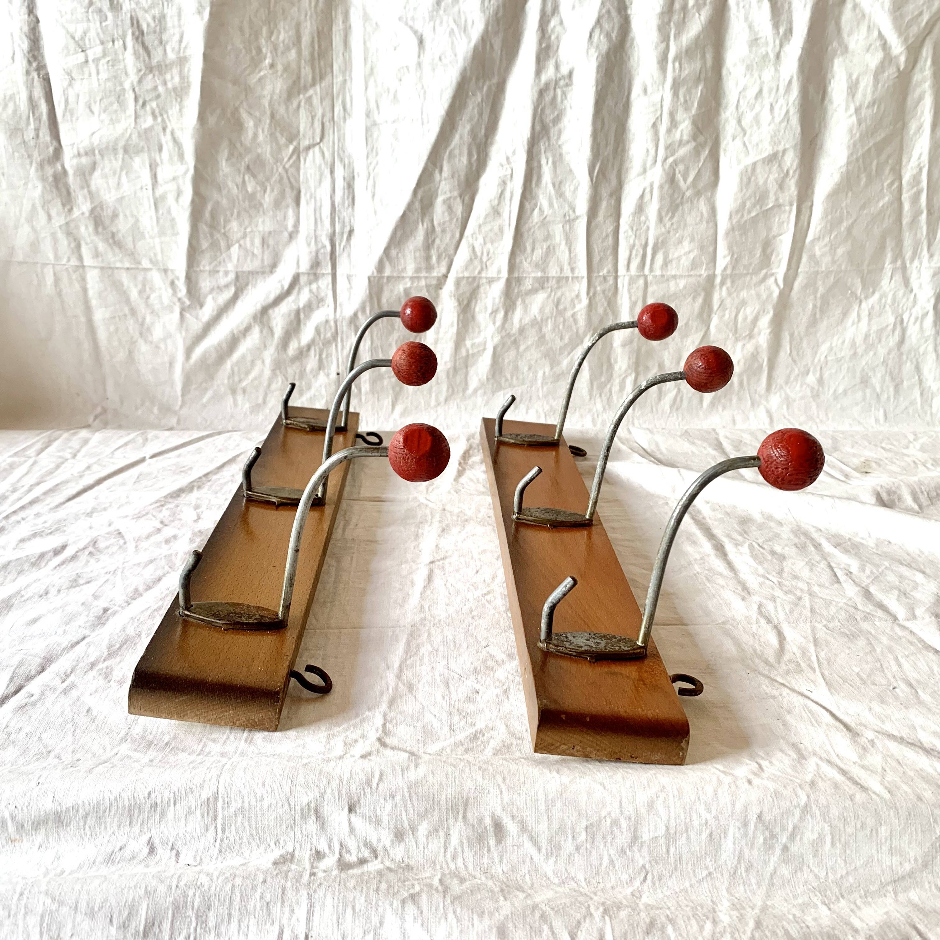 Pair of vintage wooden wall coat racks with three red ball hooks