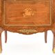 In-between furniture in marquetry decorated with a trophy decoration of musical instruments