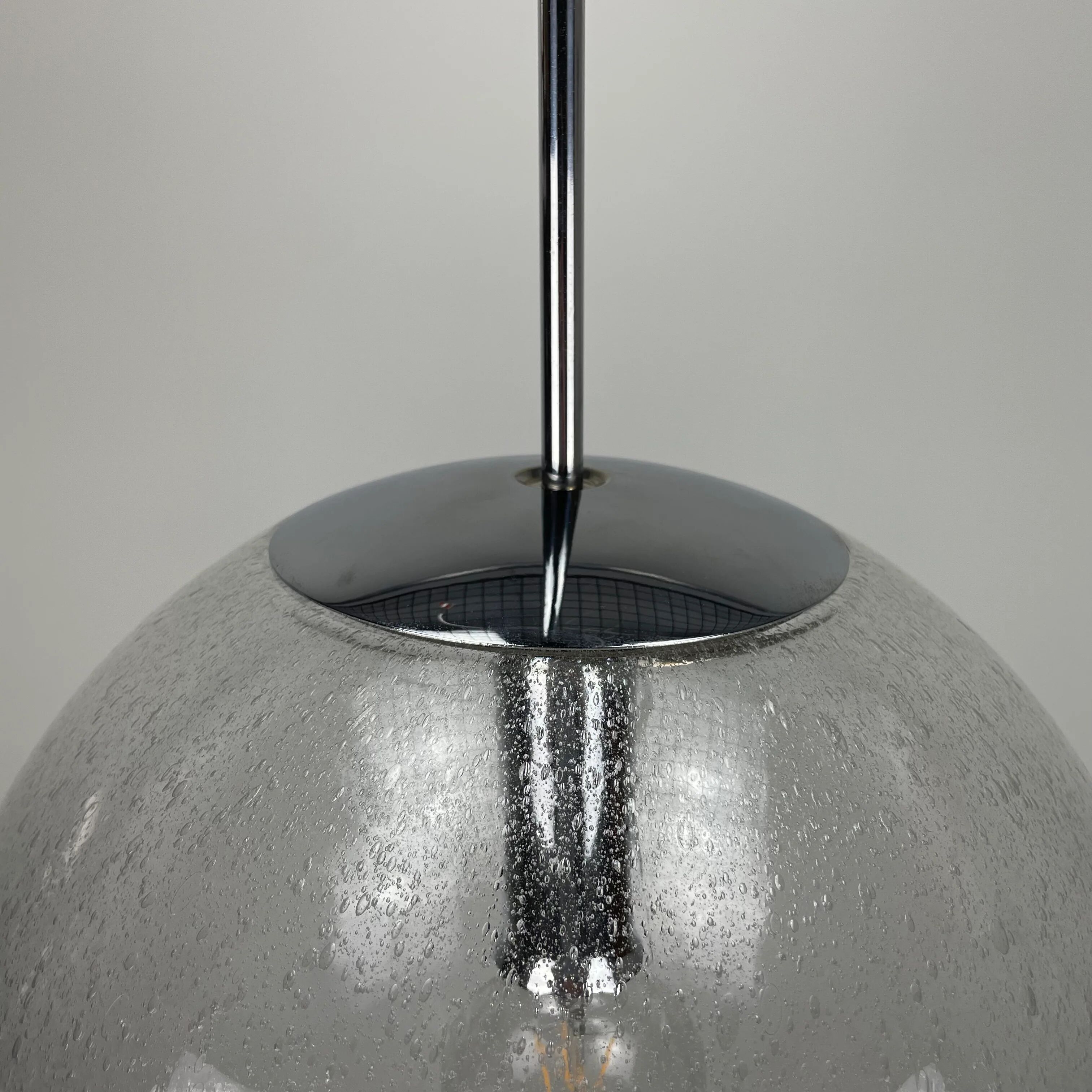 Large suspended lamp with a glass globe featuring bubbles by Peill & Putzler 1970.