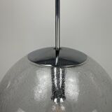 Large suspended lamp with a glass globe featuring bubbles by Peill & Putzler 1970.