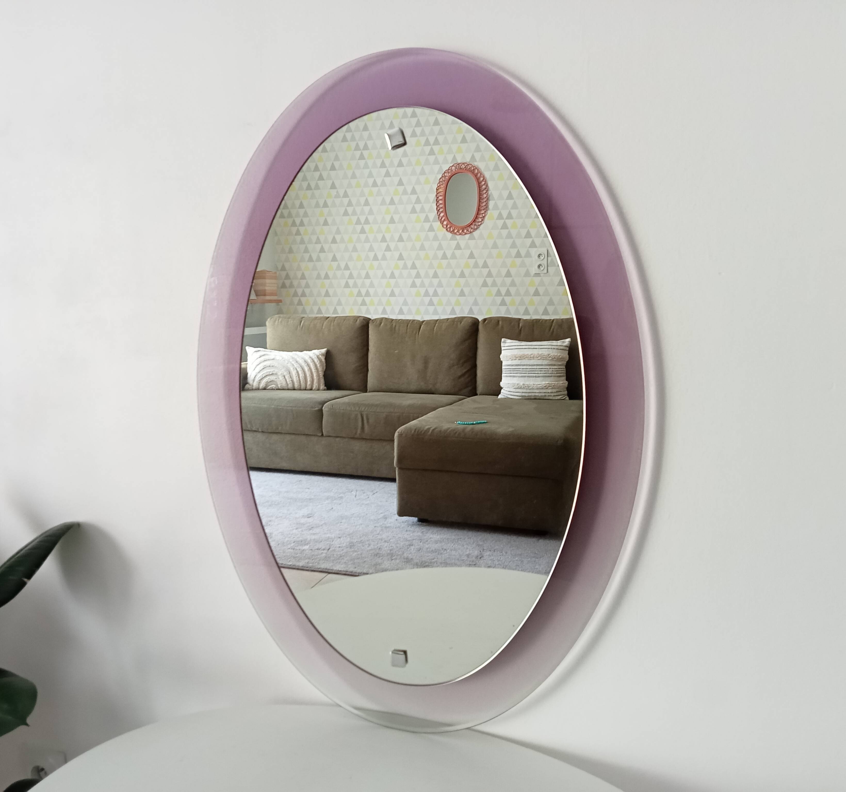 Vintage oval plexiglass mirror from the 70s by Harvey Guzzini