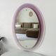 Vintage oval plexiglass mirror from the 70s by Harvey Guzzini