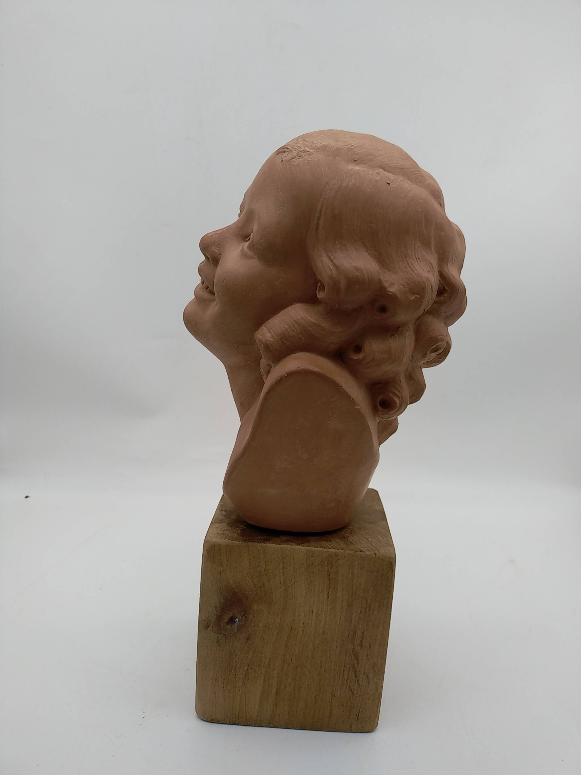 Bust young smiling girl. Circa 1900. Art Deco. Signed.