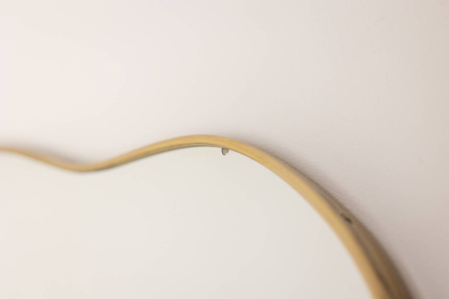 Pair of mirrors in the style of Gio Ponti, brass frame, 1980s.