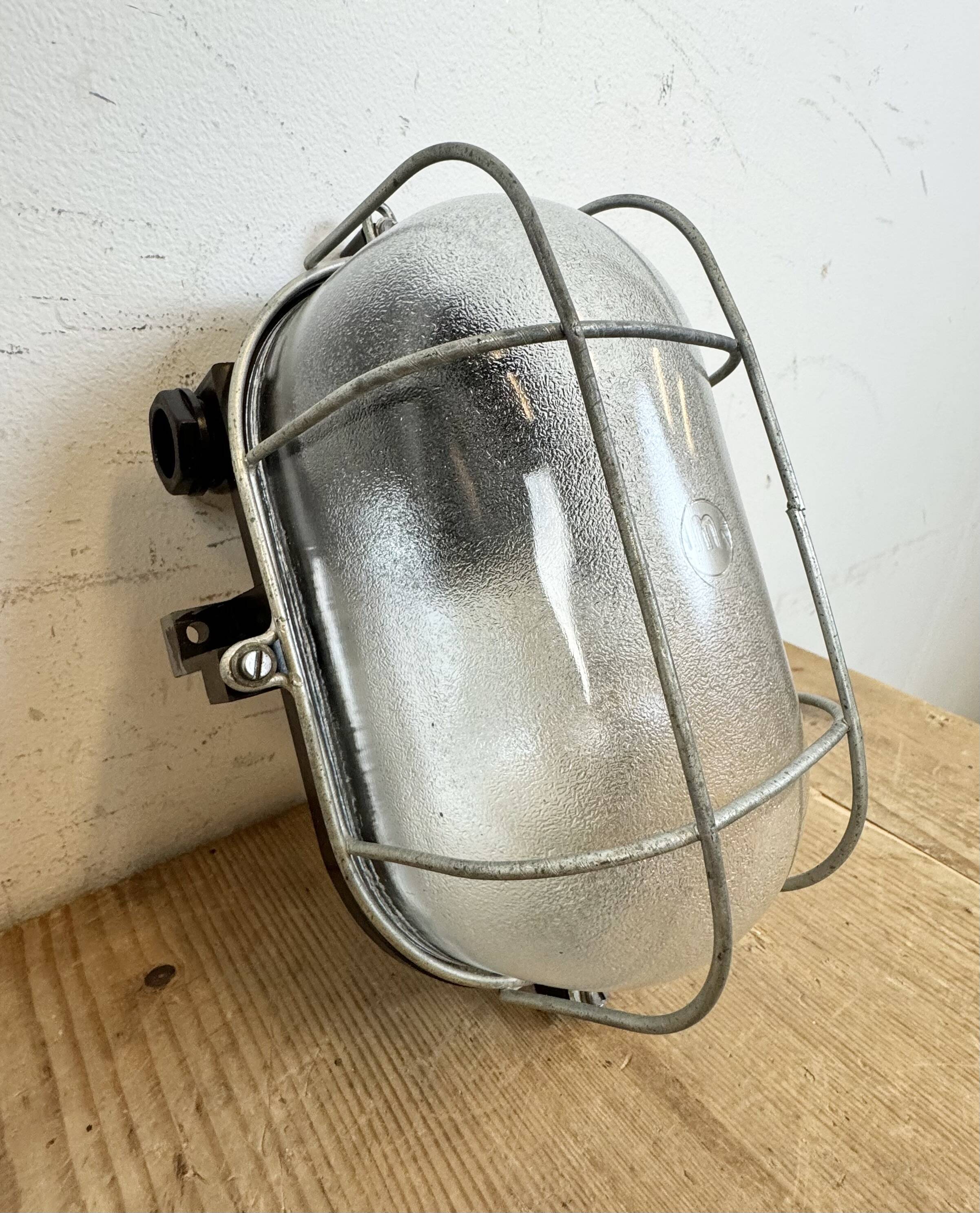 Industrial brown bakelite wall light with frosted glass, 1960s