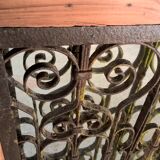 Old wrought iron railing with mirror and teak frame