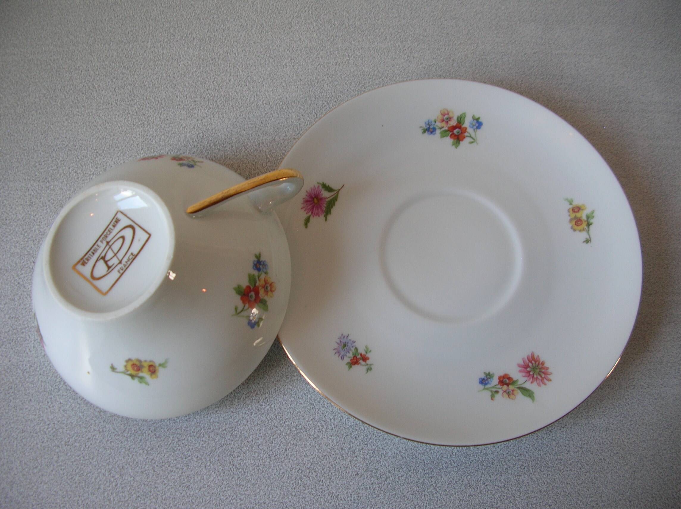 Old large tea cup and saucer in Limoges porcelain with flower decor