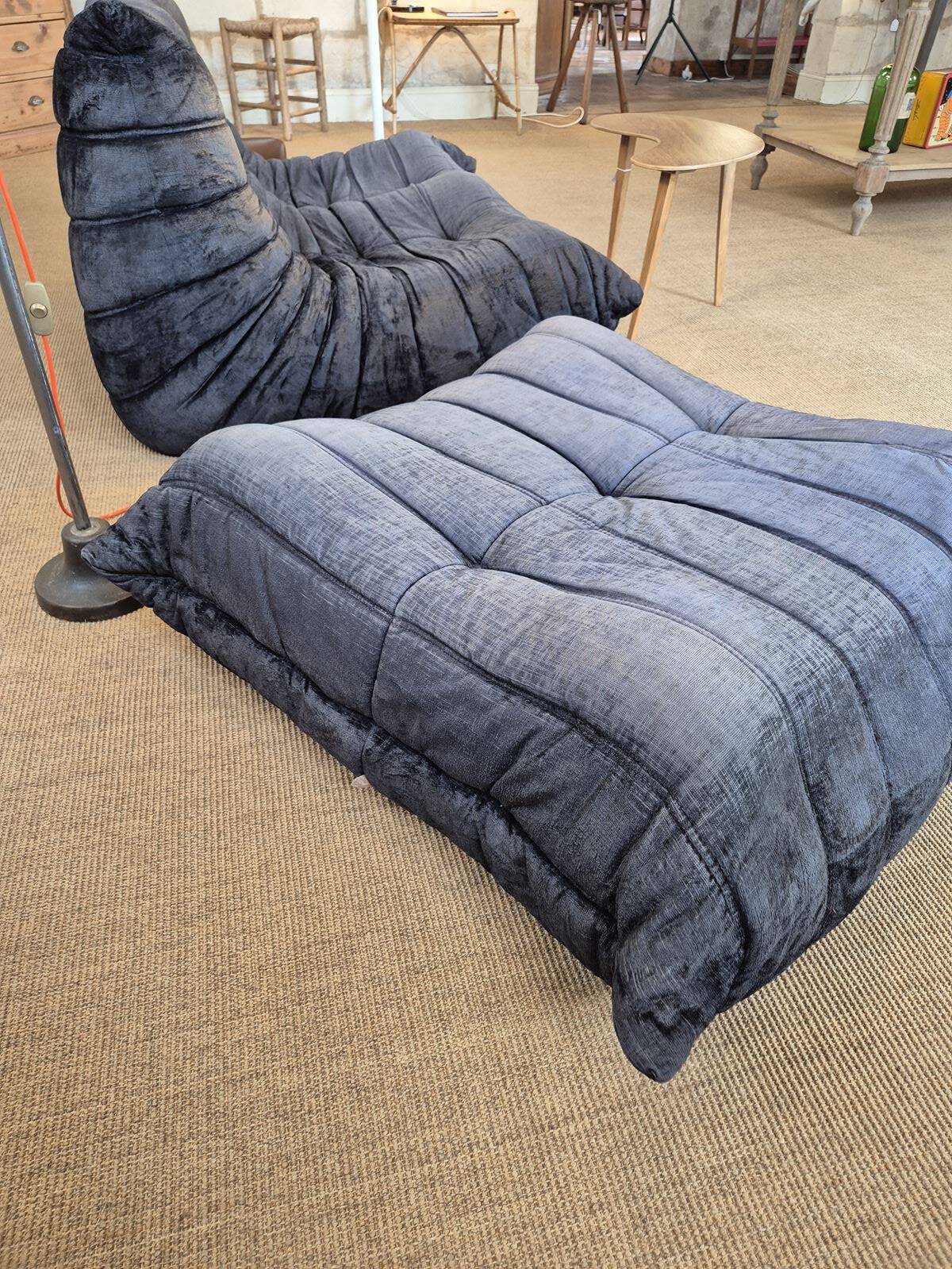 Togo sofa by Ligne Roset and its pouf from the 1970s.