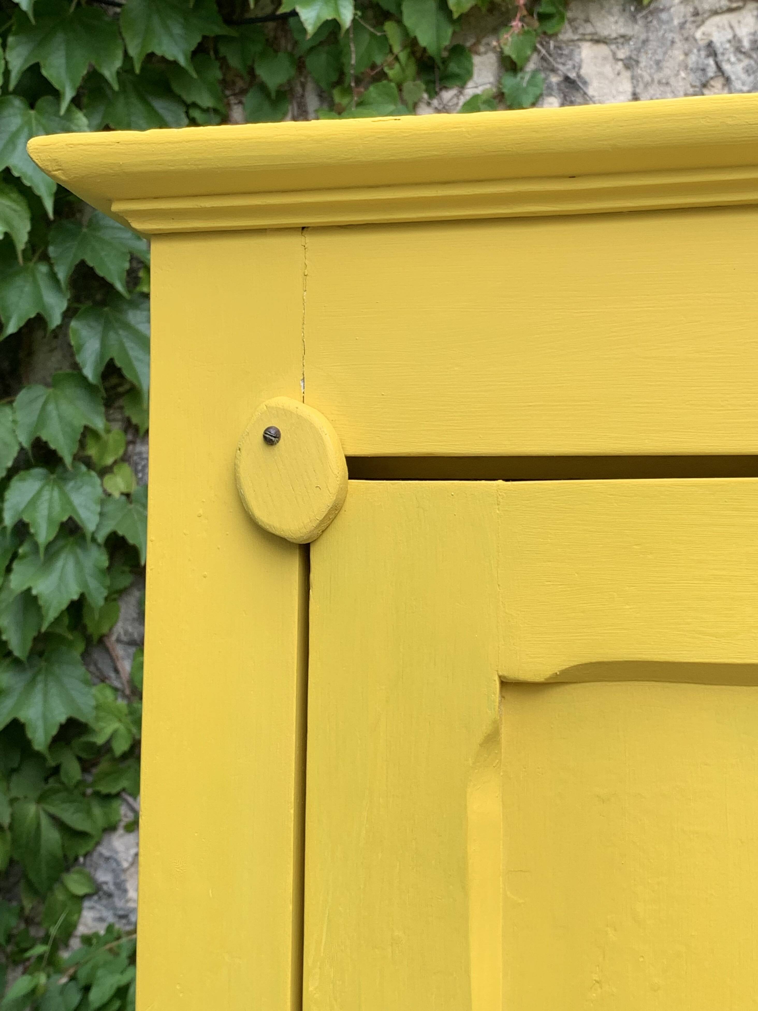 Antique powder yellow Parisian bonnetière wardrobe.