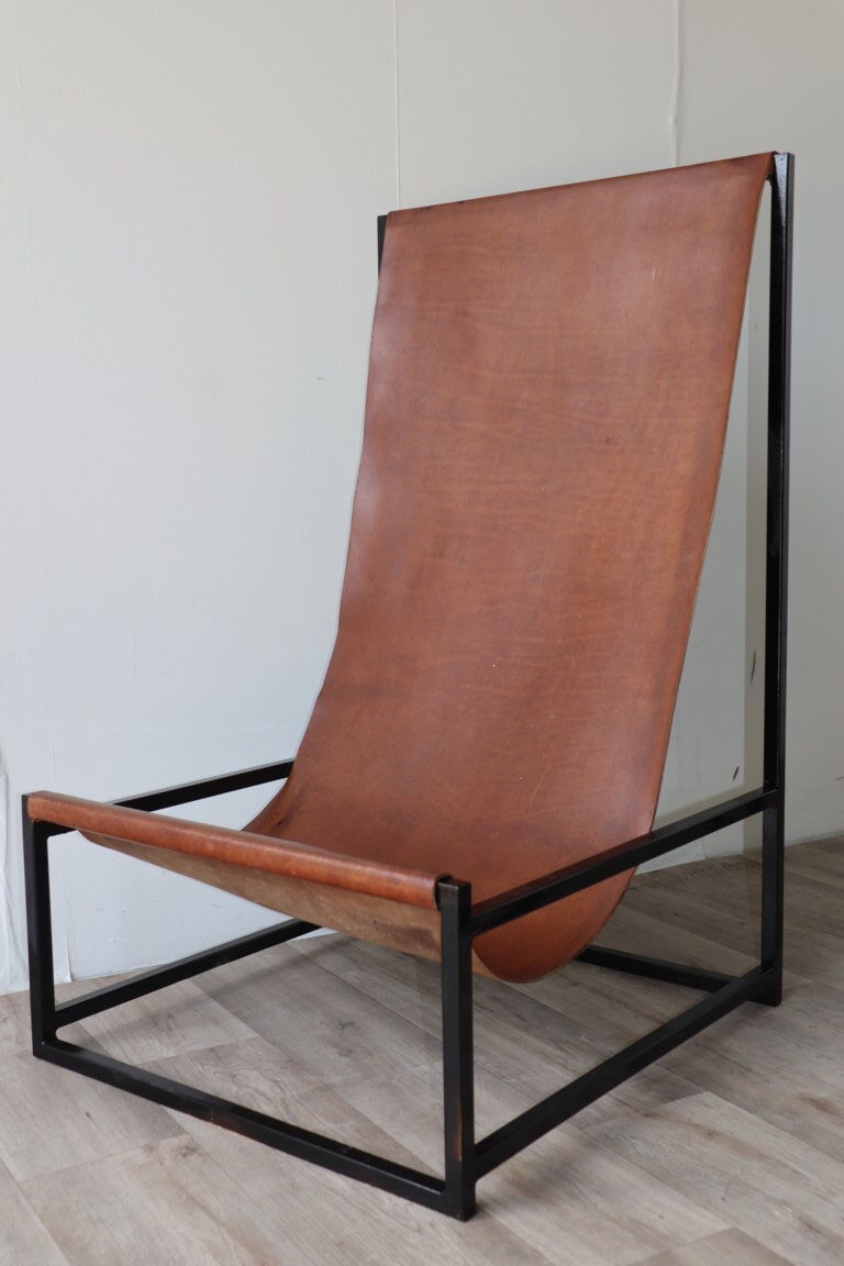 Pair of vintage armchairs in stretched leather and metal structure