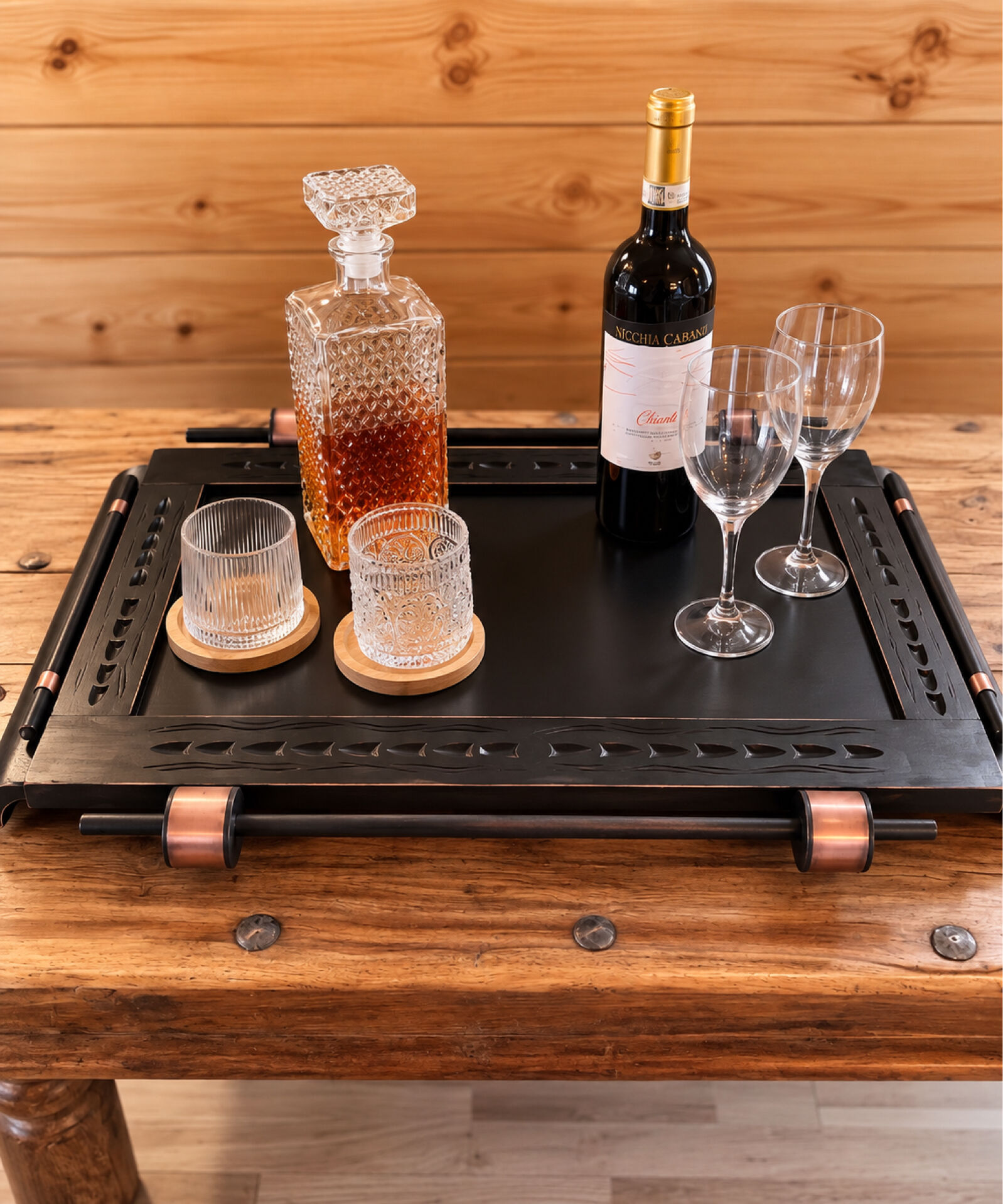 Renovated vintage bar cart in black and copper with removable serving tray.