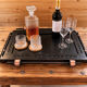 Renovated vintage bar cart in black and copper with removable serving tray.