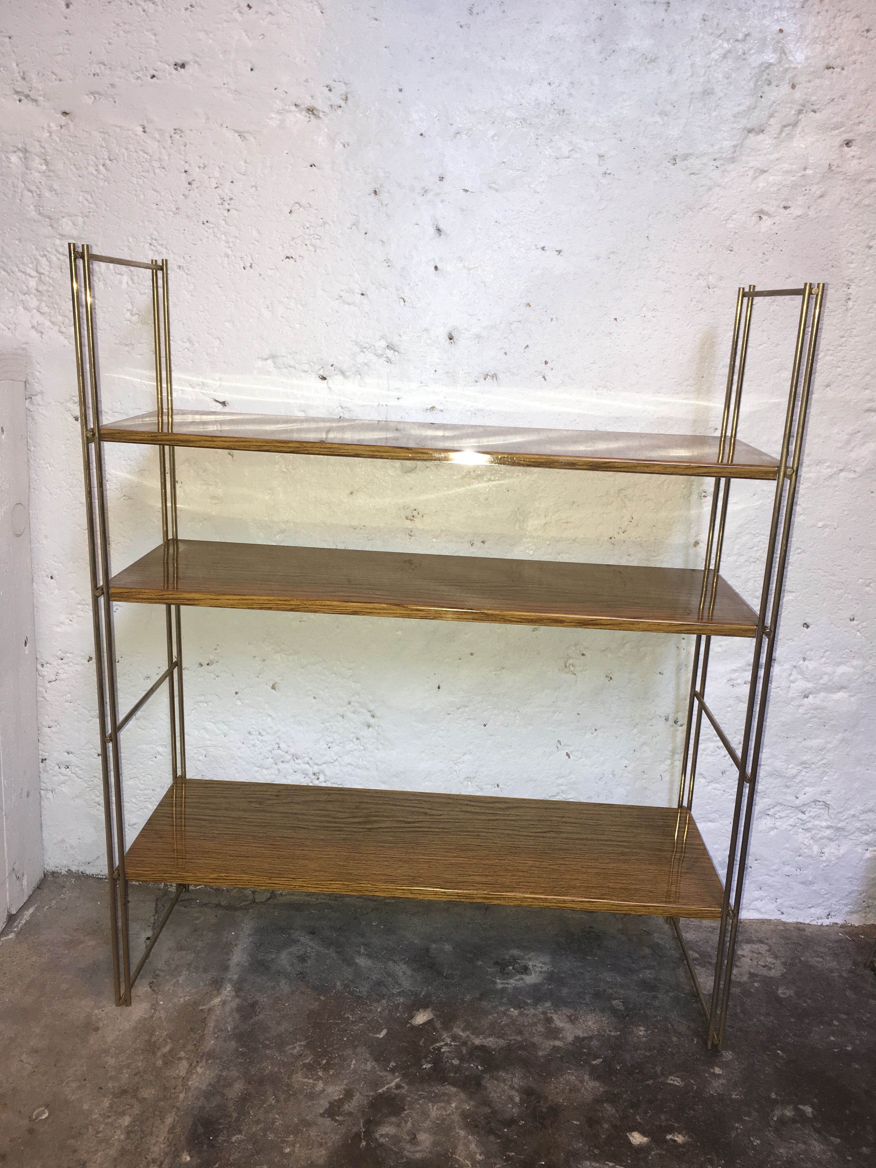 set of two 1960 vintage metal thong shelves.
