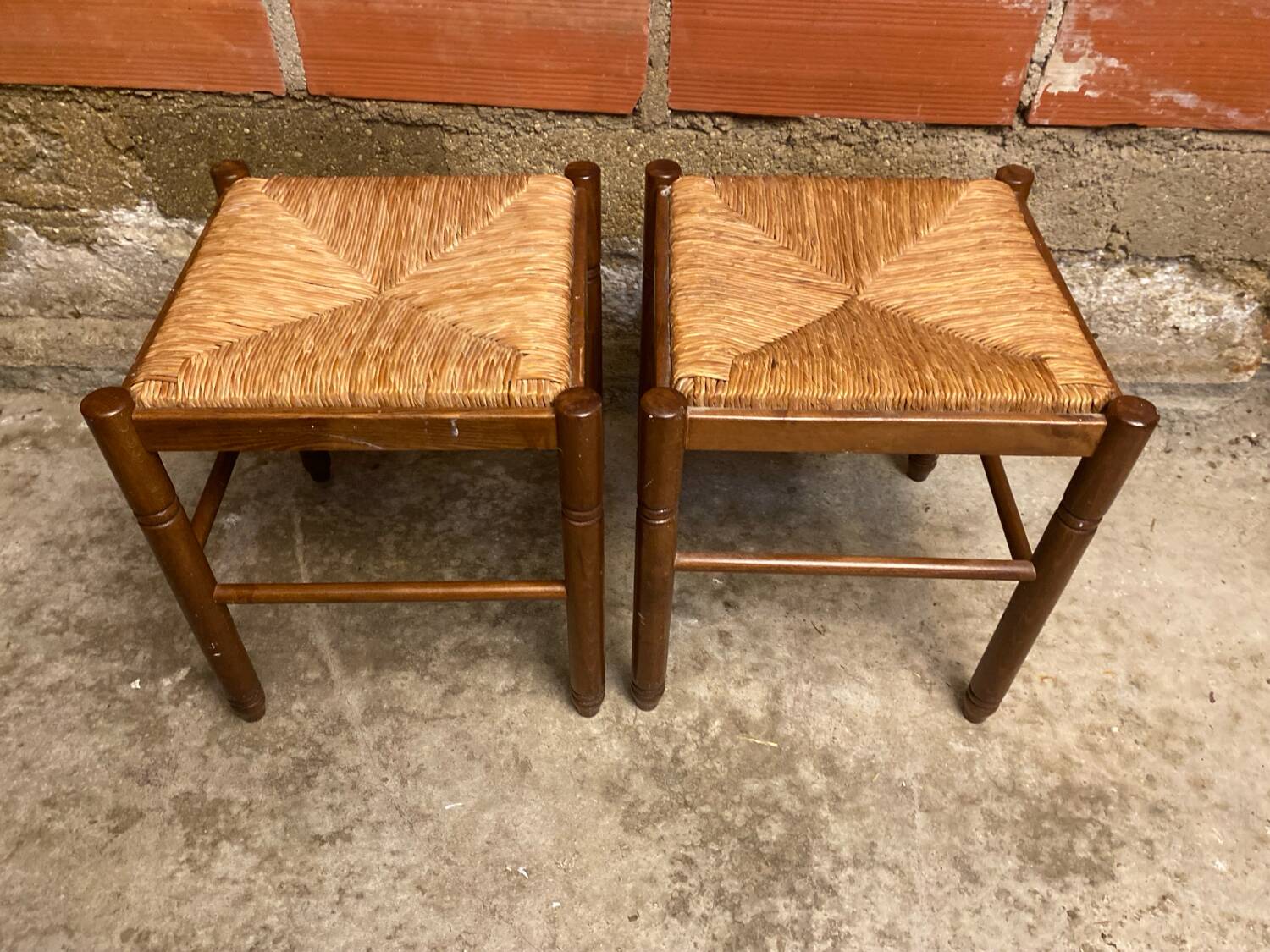 Pair of vintage wooden stools with woven straw seats