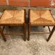 Pair of vintage wooden stools with woven straw seats