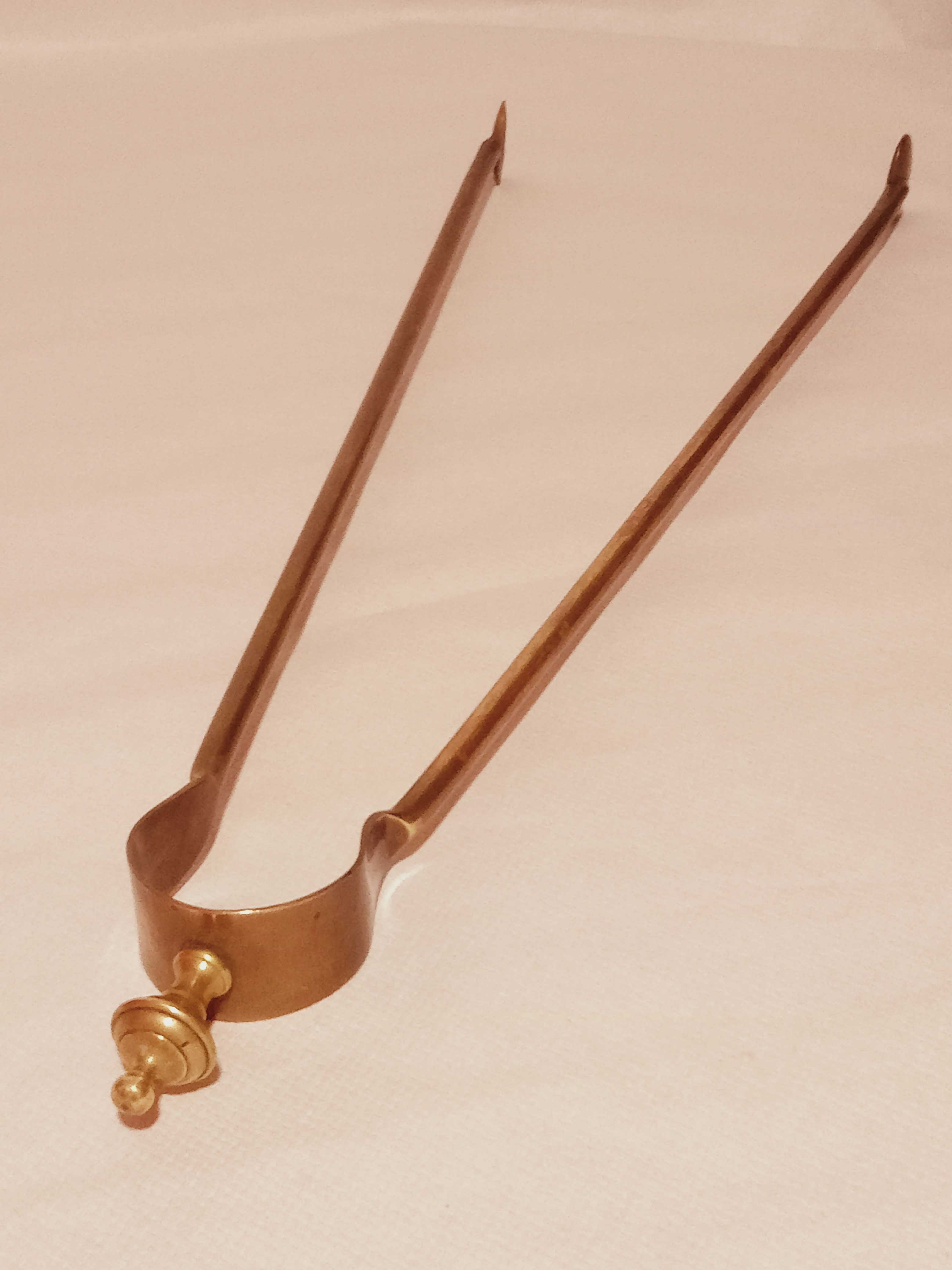 Old bronze or brass fireplace clamp