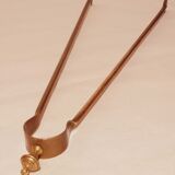 Old bronze or brass fireplace clamp