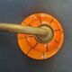 Art Deco wall light in brass with an orange globe.