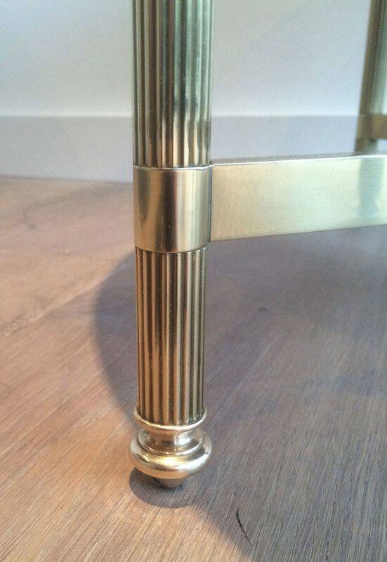 Round coffee table in brass with a black lacquered glass top by Maison Jansen.