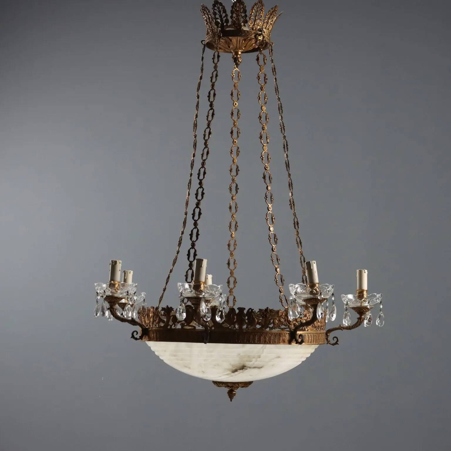 Antique chandelier in gilded bronze with neoclassical decorations from the 19th century.