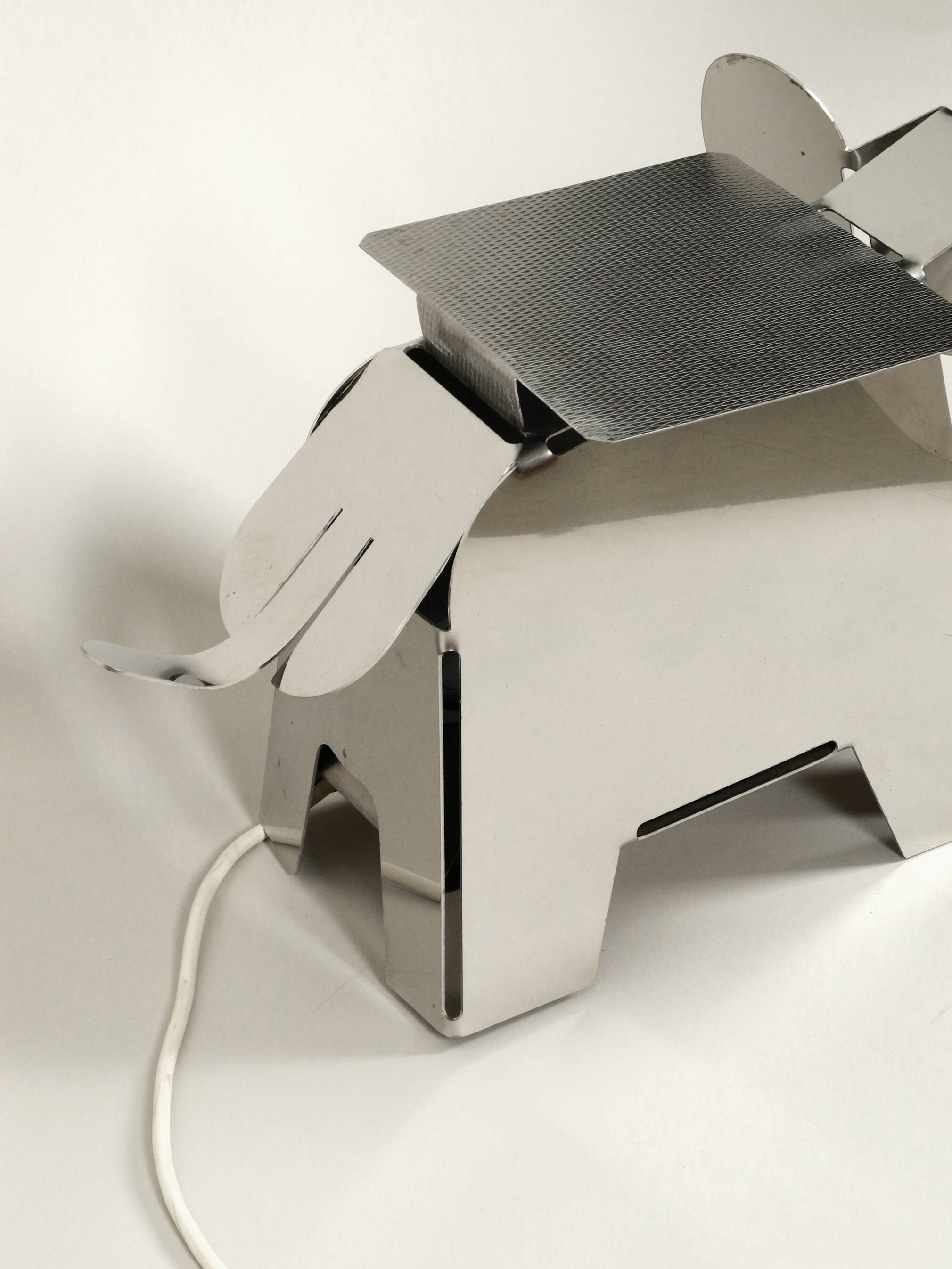 80s heavy metal chrome elephant floor lamp as side table Postmodern design