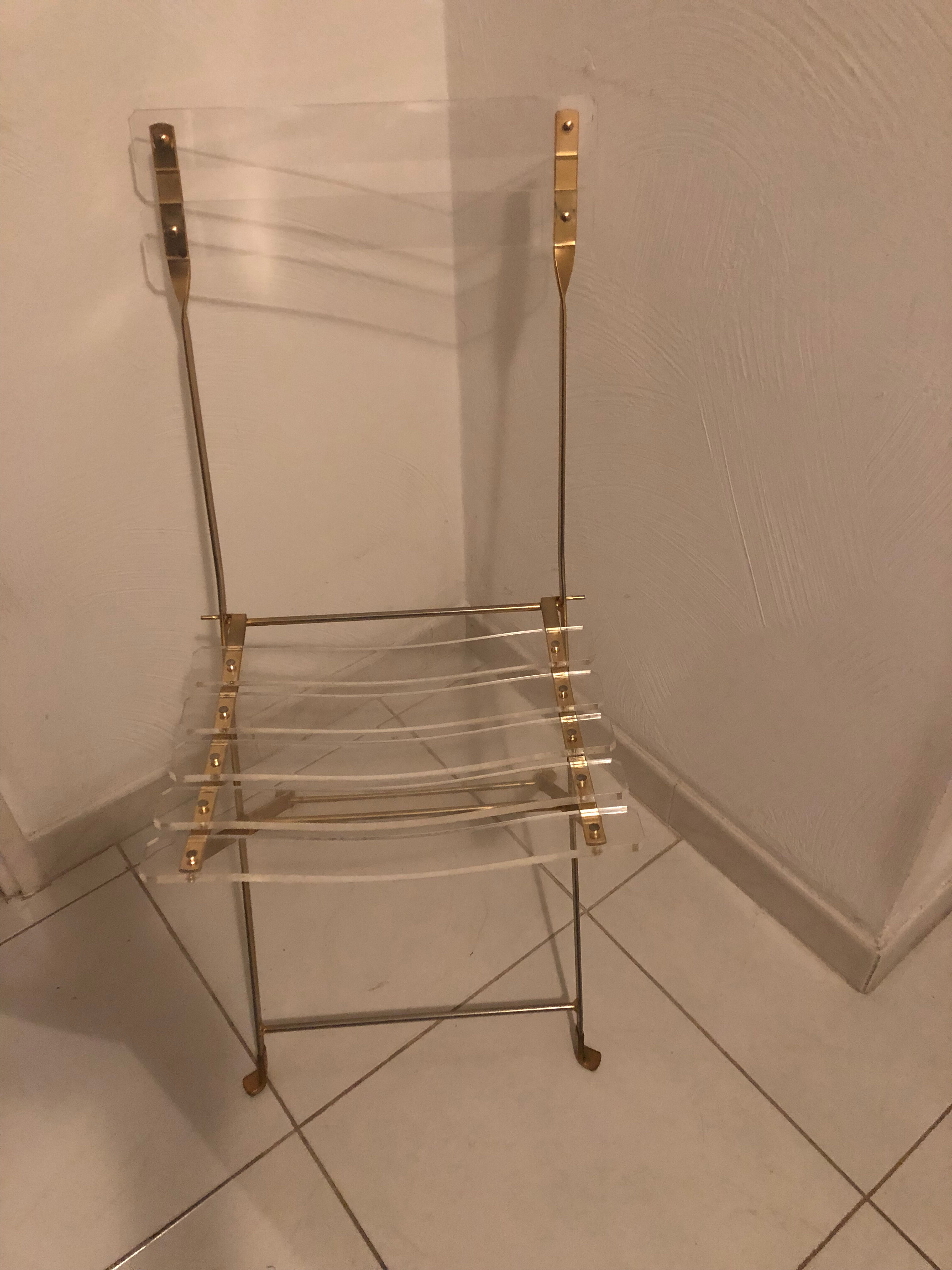 Folding chair in plexiglass and brass